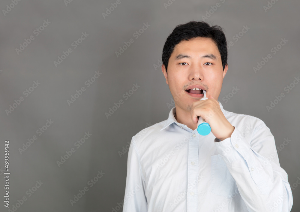 Young man brushing teeth with electric toothbrush Young man brushing teeth with electric toothbrush