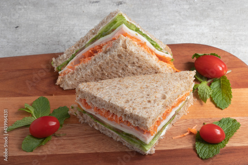 healthy sandwich with integral bread, carrots, ham, lettuce and mozzarella . photo