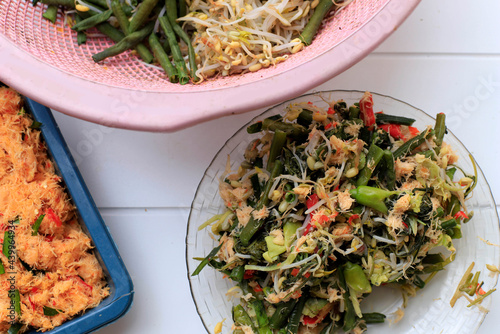 Urap Sayur, Indonesian Traditional Salad Dish Made from Various Steamed Vegetables Mixed with Seasoned and Spiced Grated Coconut for Dressing photo
