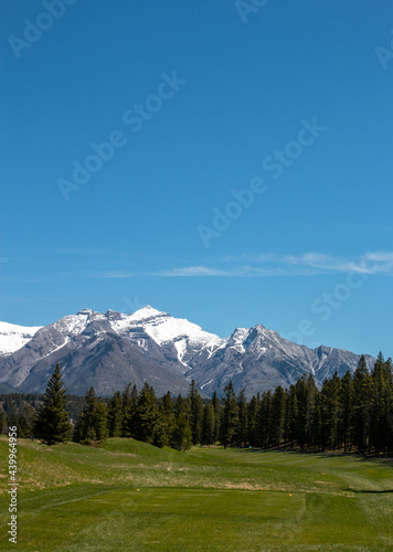 Golf course in the mountains on a sunny day. Leisure and summer sports concept