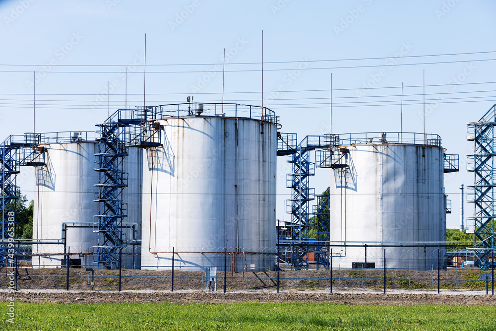 Fototapeta premium Storage of chemical products like oil, petrol, diesel fuel at clear summer day.