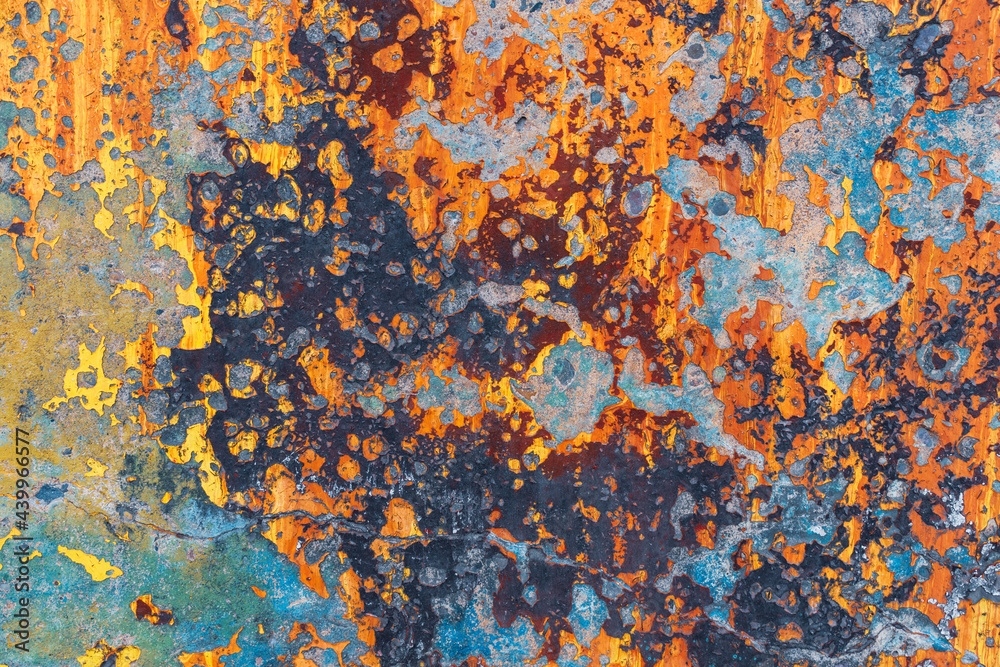 Concrete surface with old colorful paint. Color - orange, black, blue, brown. Concept of the autumn color combination.