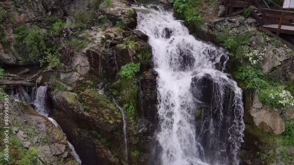 Slow motion beautiful waterfall in green forest, top view Slow motion beautiful waterfall in green forest, top view