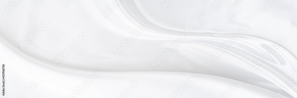 White gray satin texture that is white silver fabric silk panorama background with beautiful soft blur pattern natural.