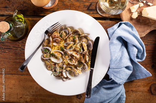 Seafood linguine pasta with clams served with wine