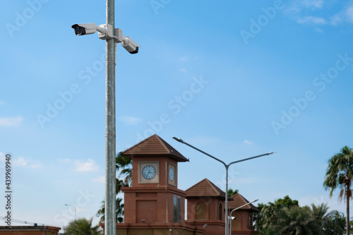 CCTV camera mounted on a pole in the blue sky background
