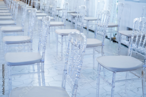 Clear plastic chiavari chairs in vintage style at weddings or events that maintain social distance and prevent the spread of COVID-19. photo