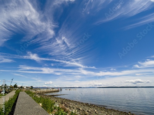 Spectacular clouds over Sidney BC shoreline  seaside boardwalk
