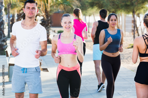 Active smiling people during running training in daytime