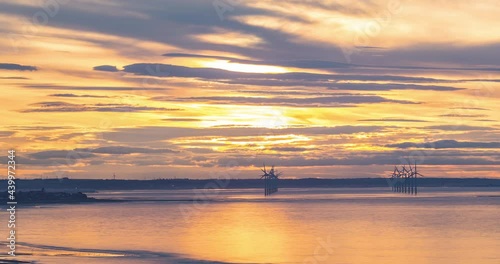 Redcar Wind Farm Time Lapse, Teesside, Towards South Gare, River Tees entrance. Golden sun setting at sunset. photo