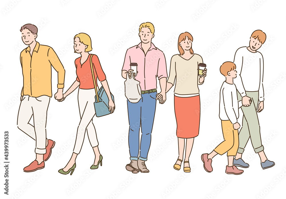 People on the street are walking hand in hand together. People on the street are walking hand in hand together.