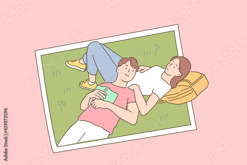 A couple is relaxing and lying together on the lawn. photo concept.