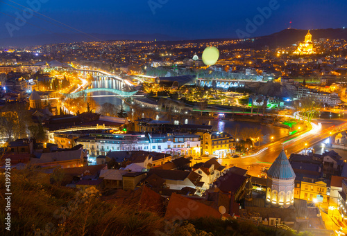 Picturesque night view of Tbilisi with bridges over Kura river, capital of Georgia