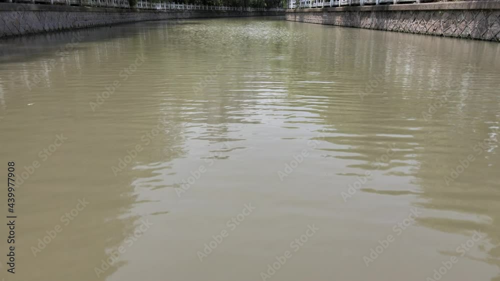 Drone flying over the river with traditional Chinese decoration. No people view. Tourism, travel or culture concept b-roll footage in Shanghai China, drone aerial view of calm water front and trees Drone flying over the river with traditional Chinese decoration. No people view. Tourism, travel or culture concept b-roll footage in Shanghai China, drone aerial view of calm water front and trees