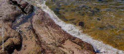 Image of rock formations (stones), with texture and sharpness, on the beach during the day photo