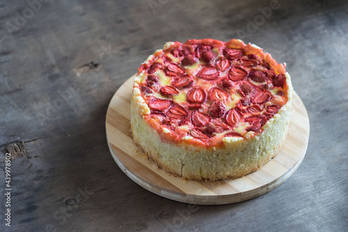 Baked strawberry pie cake tart on rustic wooden table. Selective focus