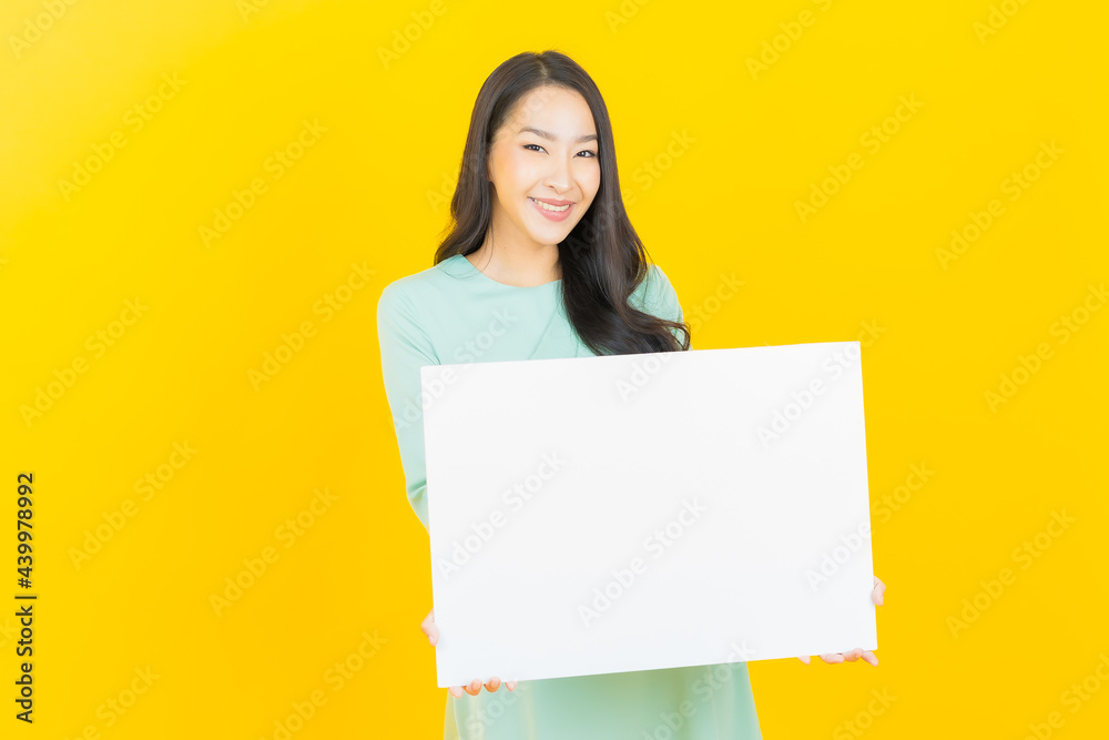 Portrait beautiful young asian woman with empty white billboard Portrait beautiful young asian woman with empty white billboard