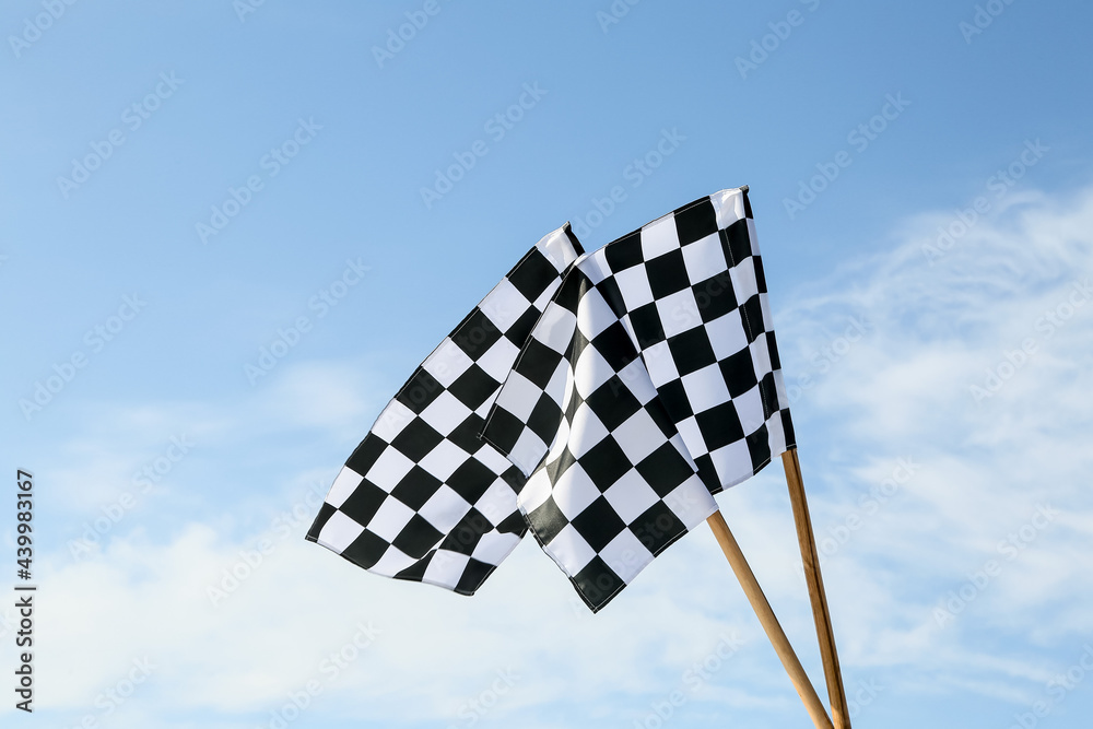 Racing flags against blue sky
