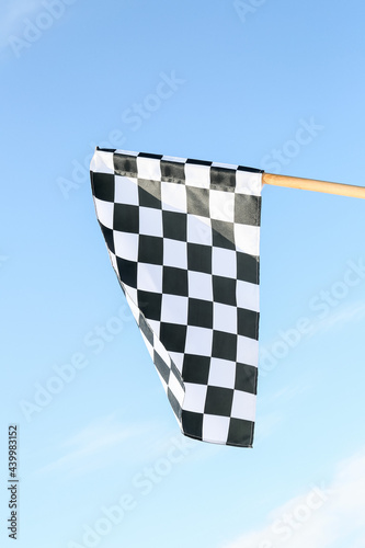 Racing flag against blue sky © Pixel-Shot