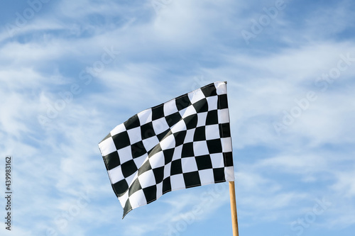Racing flag against blue sky © Pixel-Shot