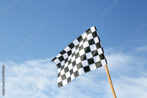 Racing flag against blue sky