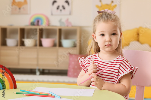 Little girl drawing at home