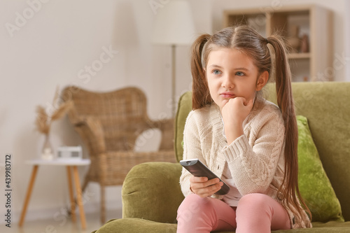 Little girl watching TV at ...