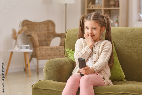 Little girl watching TV at ...