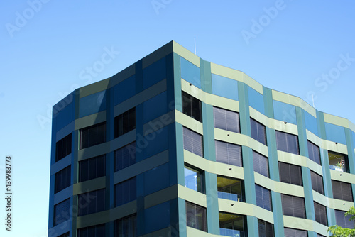 Dark green apartment building at Zurich Schlieren at a sunny summer day morning. Photo taken June 15th, 2021, Schlieren, Switzerland.