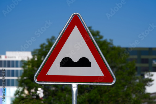 Traffic sign warning bumpy road ahead at beautiful summer day. Photo taken June 15th, 2021, Schlieren, Switzerland.