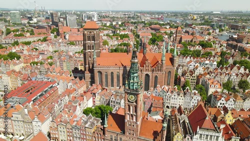 Beautiful Clock of the Town Hall in Gdansk at daytime, Poland, aerial view. Grone slow panning over Old Town in Gdansk with Amazing Architecture at Summer photo