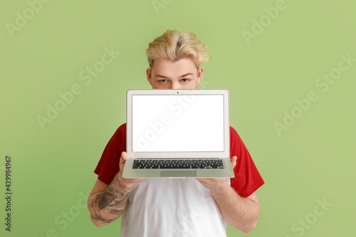Handsome man with laptop on...