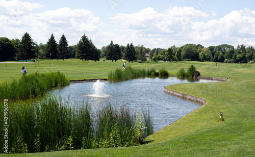Fototapeta Naklejka Na Ścianę i Meble -  Beautiful of golf club with pond and perfect green lawn and grass