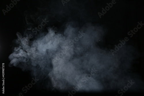 Artificial magic smoke isolated on dark background