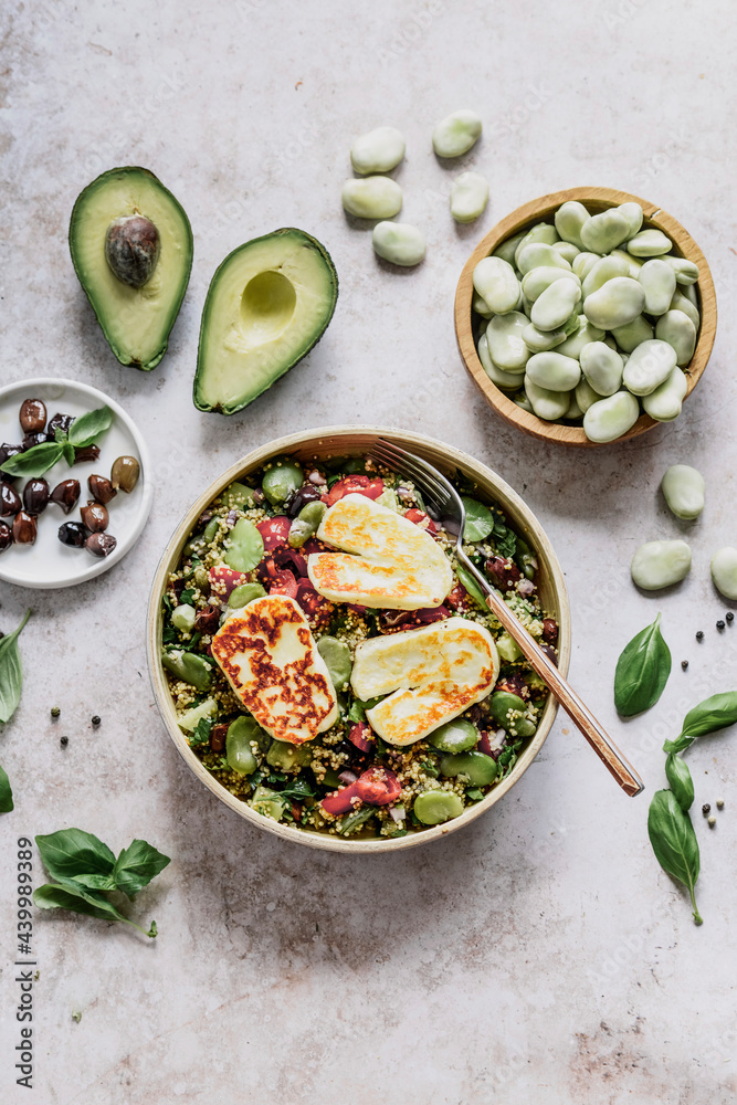 Tabuleh salad with couscous, avocado, tomatoes , broad beans olives and grilled halloumi