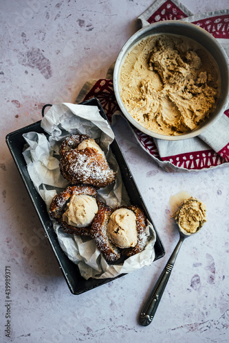 Coffee ice cream sandwich with doughnuts dipped in coocnut