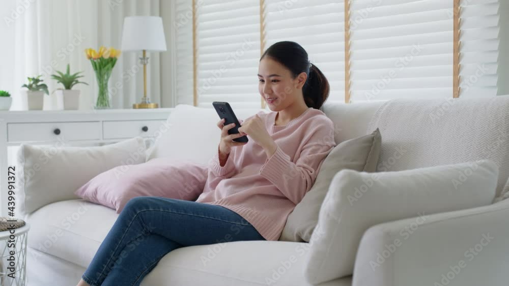 Young asia people 5G wifi digital device user teen girl watch read news play social media, e-commerce iot data app, pay money, remote shop retail store at home sofa couch sit easy relax happy smile. Young asia people 5G wifi digital device user teen girl watch read news play social media, e-commerce iot data app, pay money, remote shop retail store at home sofa couch sit easy relax happy smile.