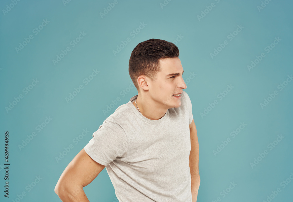 handsome man in t-shirt gesturing with his hands cropped view blue background handsome man in t-shirt gesturing with his hands cropped view blue background