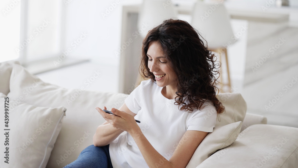 Woman with mobile phone home, beautiful brunette young happy model using smartphone Woman with mobile phone home, beautiful brunette young happy model using smartphone