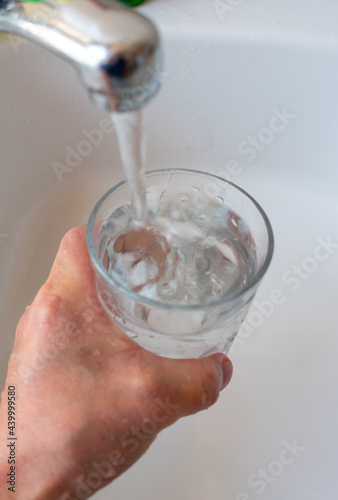 tap water pouring in a glass.