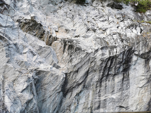 A view from below of the marble section of the Marble Canyon in the Ruskeala Mountain Park on a sunny summer day.