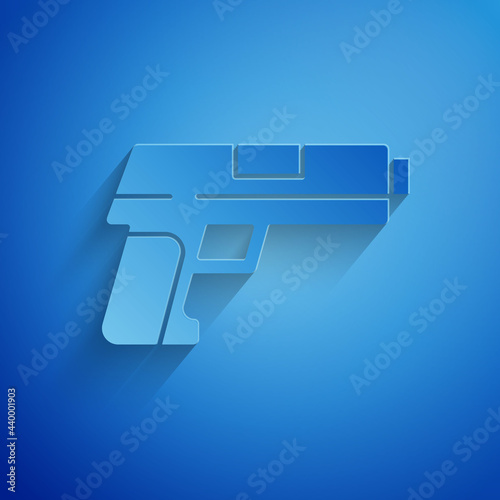 Paper cut Pistol or gun icon isolated on blue background. Police or military handgun. Small firearm. Paper art style. Vector