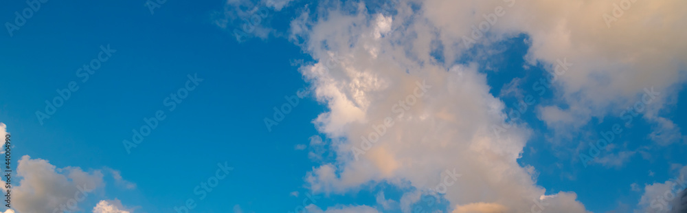 Banner Tropical summer blue sky fluffy white cloud summertime on light sunny day cloudscape. Panoramic Clear bright blue skyline spring sunlight climate background. Heaven blue ecology for web banner Banner Tropical summer blue sky fluffy white cloud summertime on light sunny day cloudscape. Panoramic Clear bright blue skyline spring sunlight climate background. Heaven blue ecology for web banner