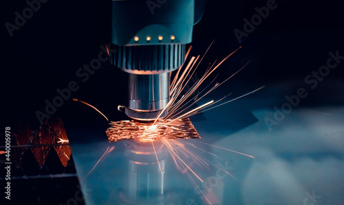 Macro photo cutting of metal CNC Laser engraving. Concept background modern industrial technology
