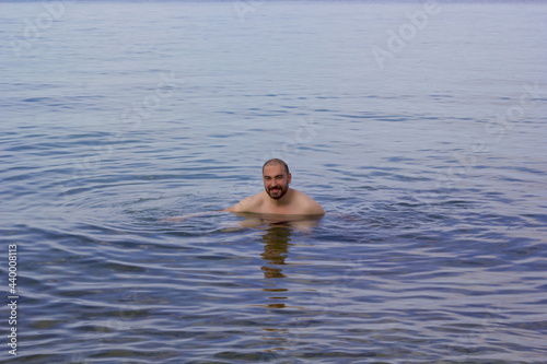 handsome young man swimming in the sea in summer vacation