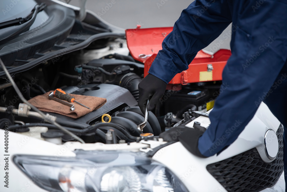 Mechanic checking engine after car breakdown Mechanic checking engine after car breakdown