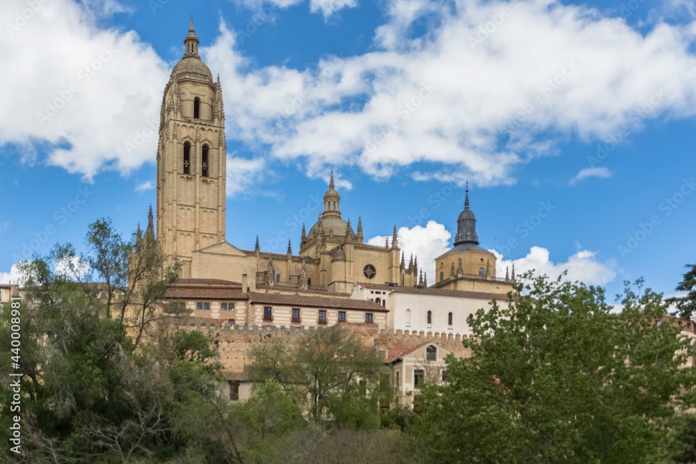 Majestic view at the iconic spanish gothic building at the Segovia cathedral, tower dome and surrounding vegetation