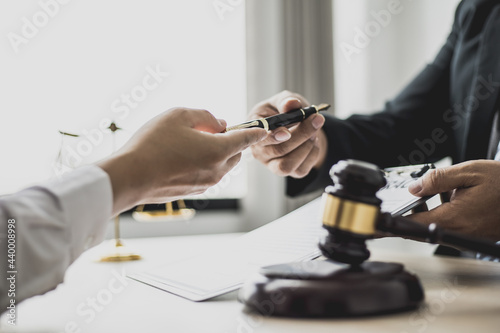 Attorney gives the client a pen to sign a contract admitting fraud, lawyer admits a fraud case in which client is a victim and will sue defendant who is a commercial partner. Fraud litigation concept.