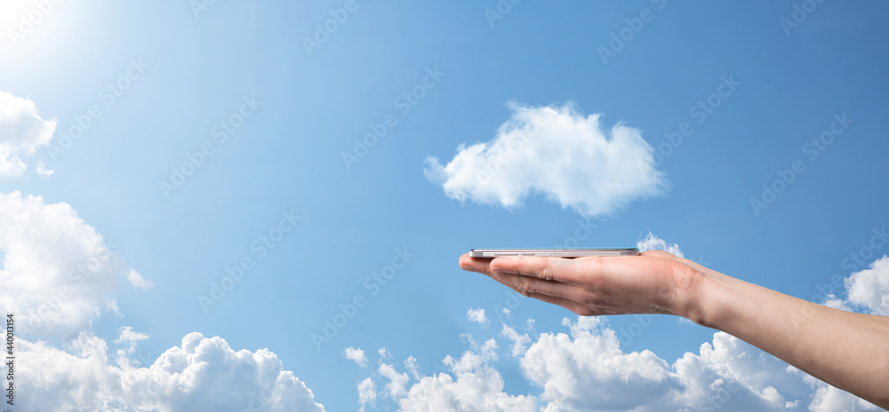 Male hand holding house icon on blue background. Property insurance and security concept.Real estate concept.Weather conditions, cloudiness.Banner with copy space Male hand holding house icon on blue background. Property insurance and security concept.Real estate concept.Weather conditions, cloudiness.Banner with copy space