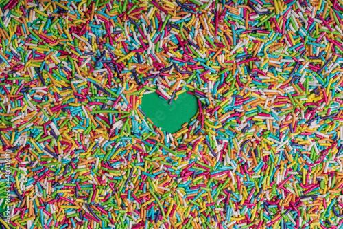 Rainbow Colored Sprinkles with Green Heart Background